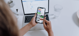 Looking at social media on cell phone and laptop