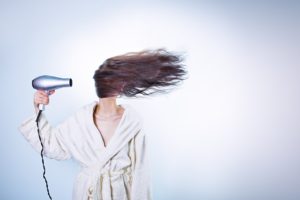 woman blow drying hair