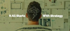 Person facing a wall covered with notes and images, with the text "It All Starts With Strategy" overlaid, along with a cloud and lightning bolt icon.