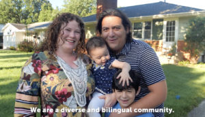 A smiling couple stands outside a house with their two young children. The text at the bottom reads, "We are a diverse and bilingual community."