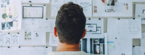 Man looking at plans on a wall