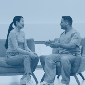 nurse and patient sitting in chairs talking.