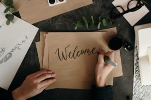 Hand writing the word Welcome