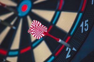 Dart Board with a dart on the number 2