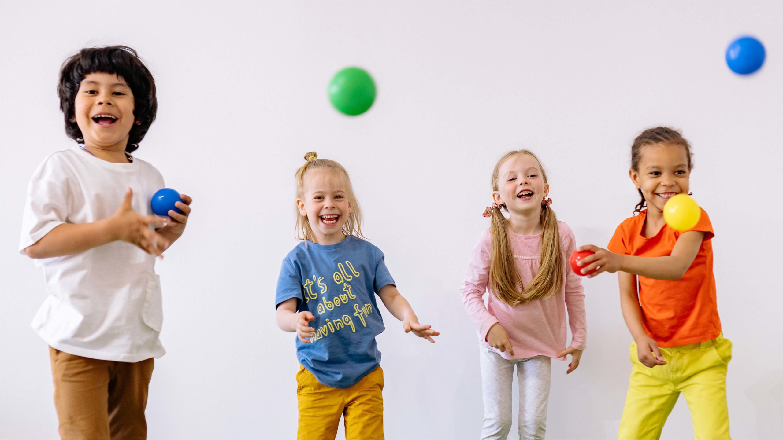 kindergarten students bouncing balls