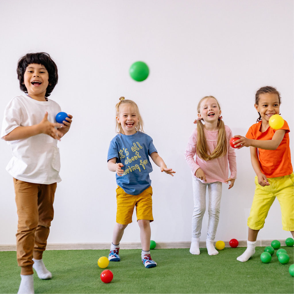 kindergarten students bouncing balls