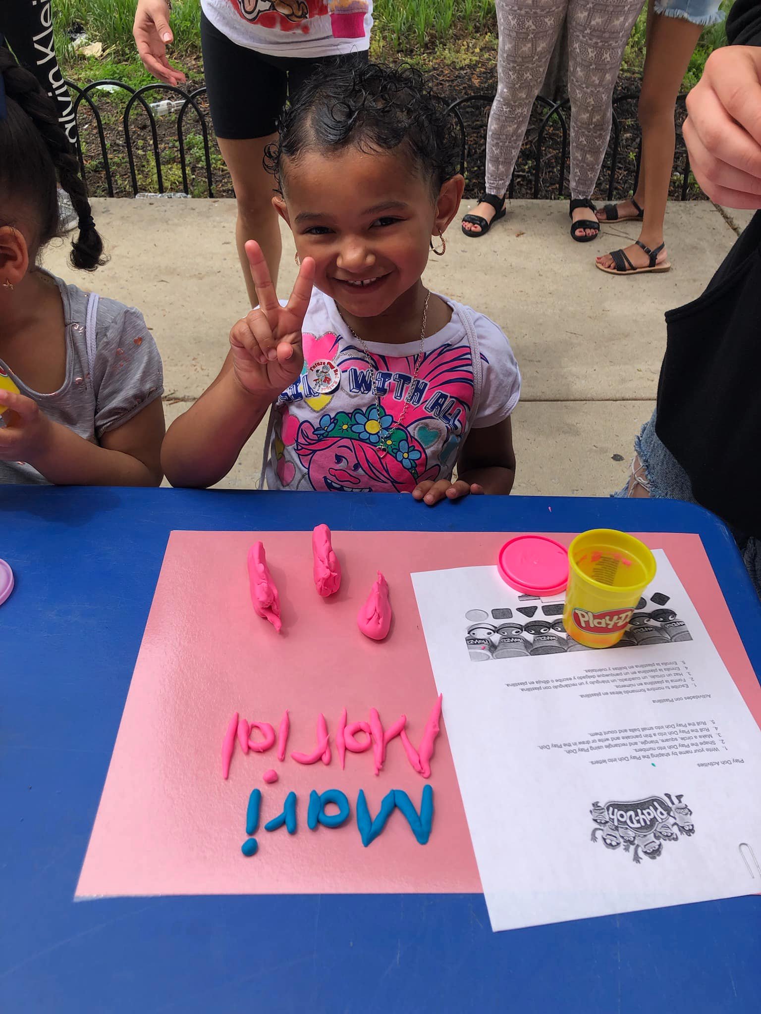 kindergartener making playdoh at red knight bus event