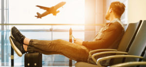 Man waiting for a flight at the airport gate.