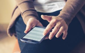 Person scrolling the internet phone