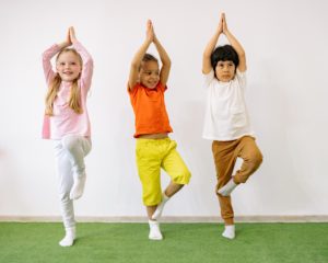 Kids doing tree yoga position