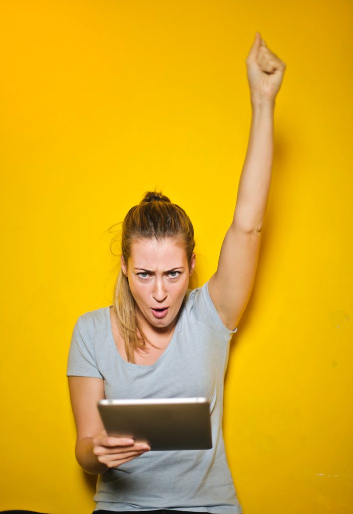 girl raising her hand in the air and cheering