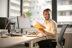 man at his desk smiling