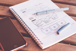 hand drawn wireframe of a website in a notebook