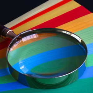 magnifying glass on colored paper