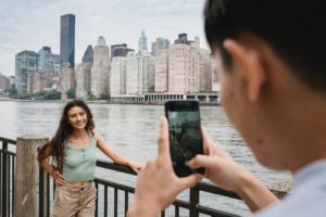 Person taking photo of another smiling person