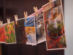 photos hanging from string with clothes pins