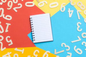 empty notebook surrounded by numbers