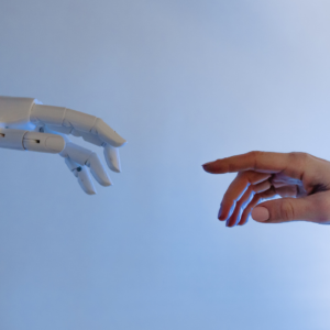 Robot hand reaching out toward human hand