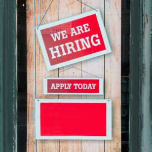 Sign on door saying "we are hiring"