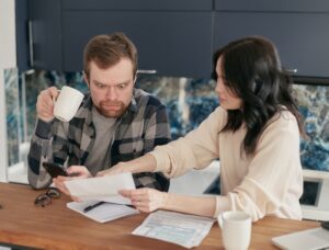 a man and a woman looking at a piece of paper