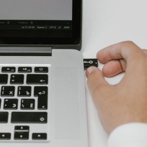 Hand putting a usb key into a laptop