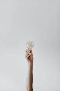 Arm holding lightbulb up into the air.