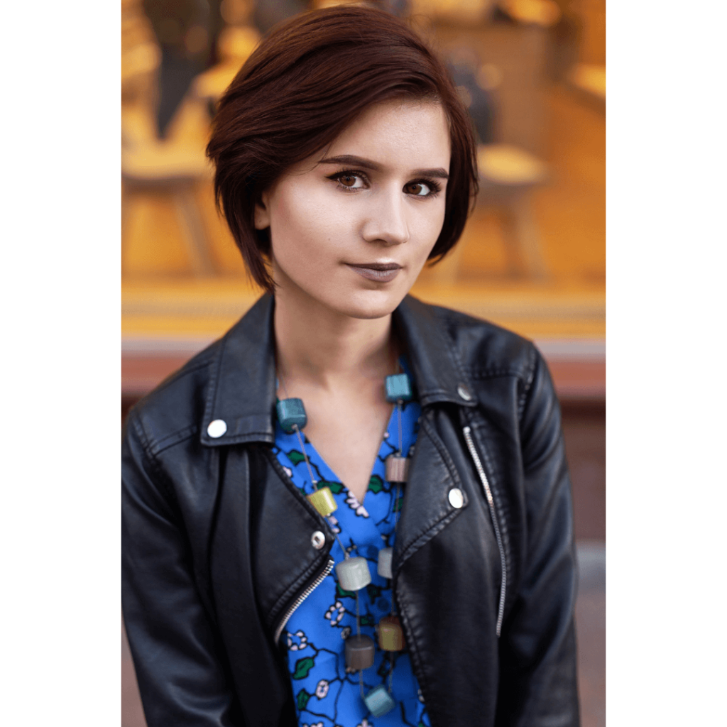 Photo of woman standing against a yellow outdoor background