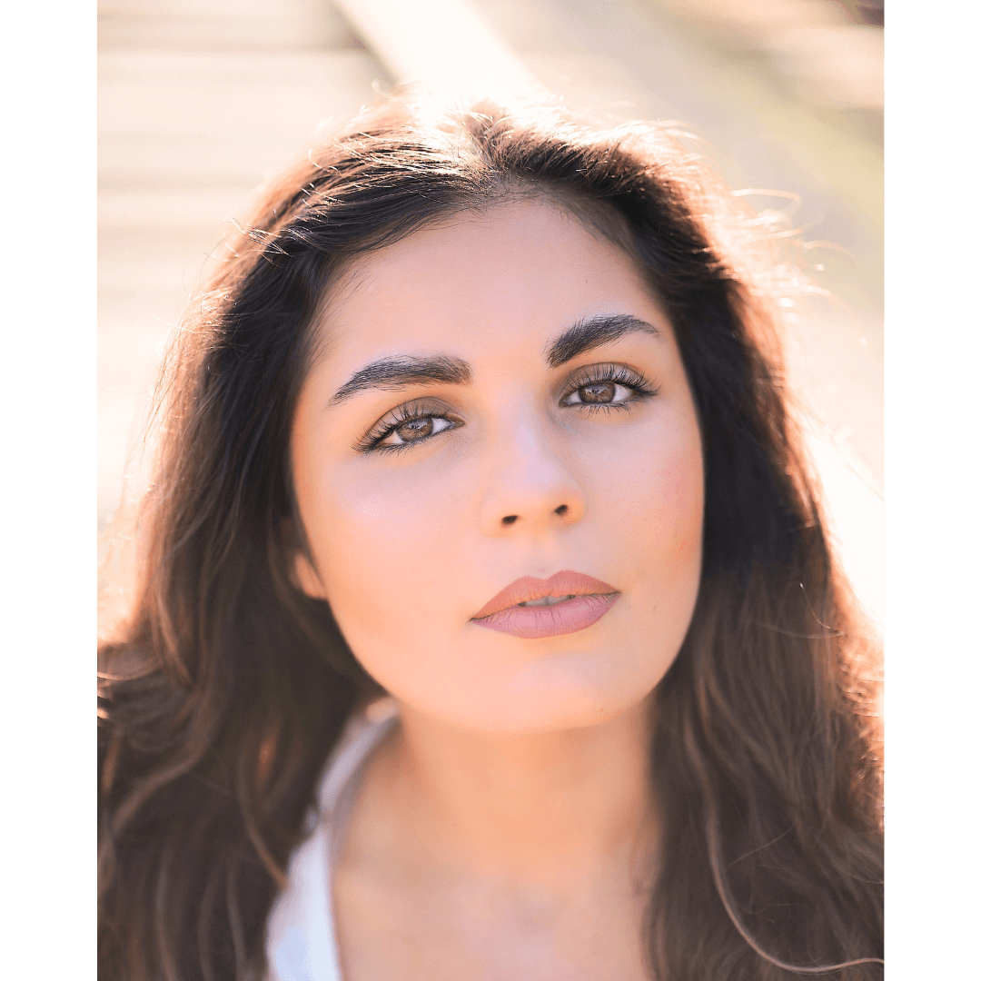 Headshot of a woman with thick makeup and airbrushed skin