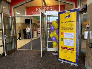 be informed banner in school entry way