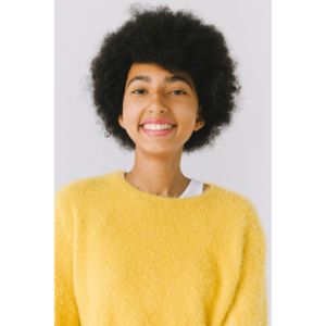Woman in a headshot with yellow sweater and white undershirt strap showing