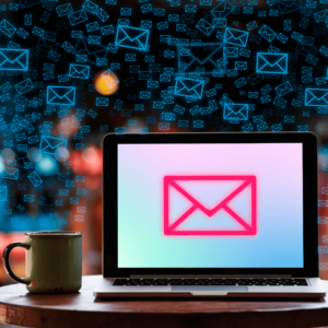 Computer with email symbol on the screen and many email symbols floating in the air