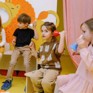 Kindergarten students in music class holding bells