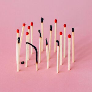A group of matches, some burned out and some intact, implying increasing burnout at work
