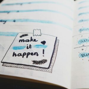 2025 School Communicator's Planner with a hand written note to "Make it happen!"