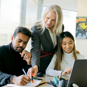 Three employees collaborating and engaged at work