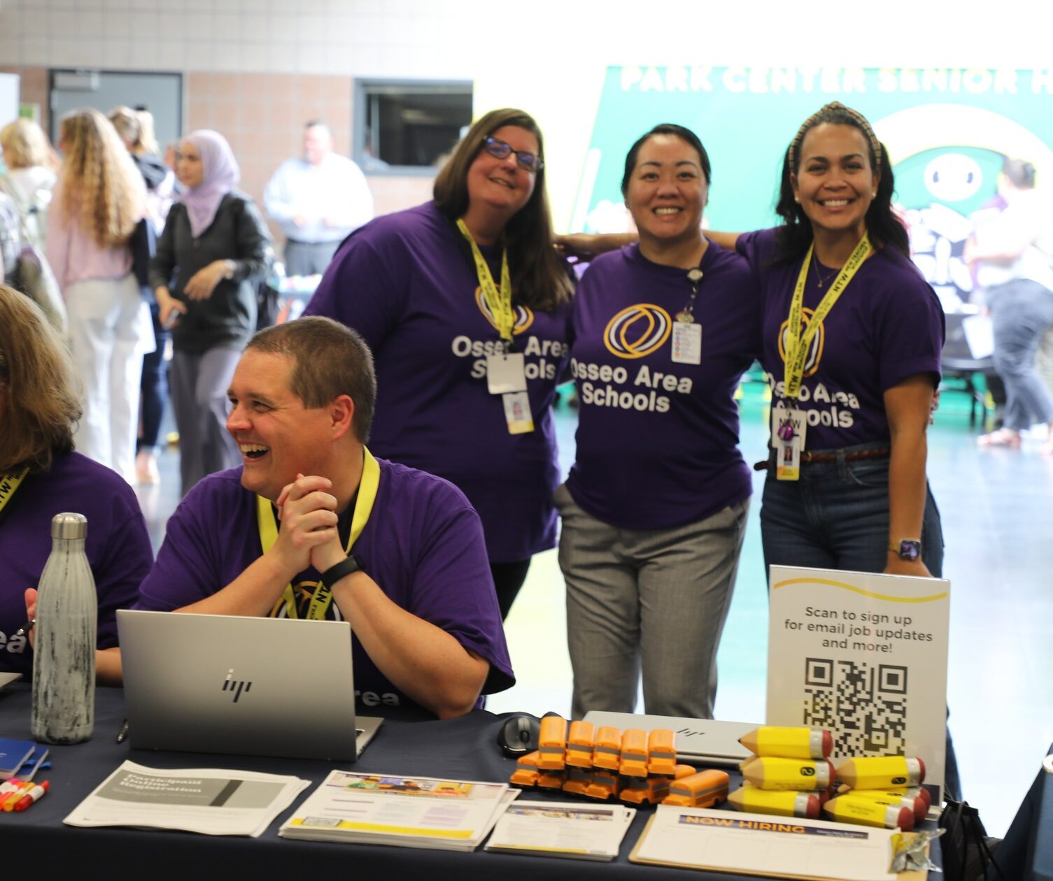 Smiling teachers at sign up table