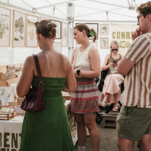 People browsing a booth at an art fair