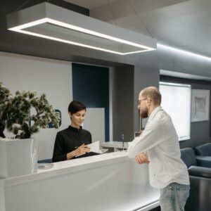 Man in White Dress Shirt Standing Near a Woman in the Reception