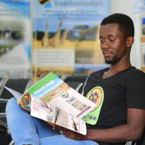 A man reading a colorful brochure