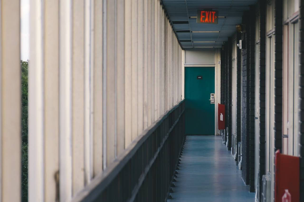 A long hallway leading toward a doorway, representing keeping opportunities for community involvement open.